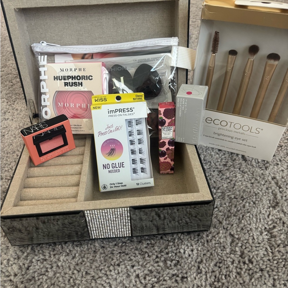 New eyeshadow brushes, blushes lashes, lip, and sponge along with jewelry box.